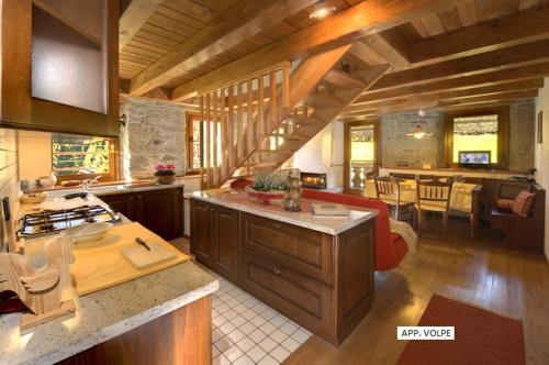 a large kitchen with a counter and a dining room at Pa' Eimbdlar in Sauris