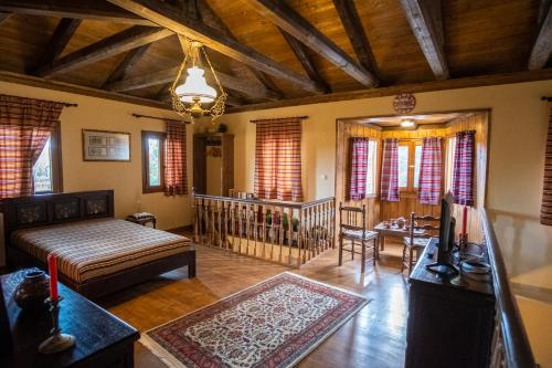 a living room with a bed and a table at villa Melissa in Kostitsi