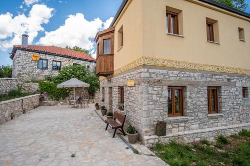 a building with a bench in front of it at villa Melissa in Kostitsi