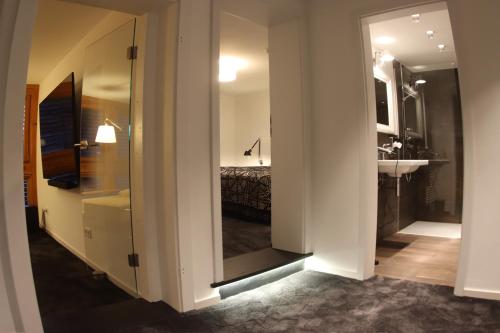 a room with a bathroom with a sink and a mirror at The Birdy Mountains Luxury Lodge 2, 230qm,Sauna,Entertainment in Schlitz