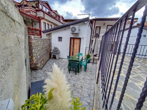 a patio with a table and chairs in a building at Old Town Patio House in Ohrid