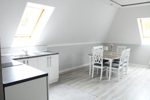 a kitchen and dining room with a table and chairs at Wodny Świat in Ostrzyce