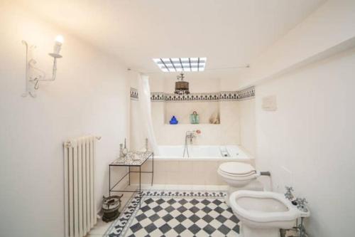 y baño con bañera, aseo y lavamanos. en Relais del mar- luxury penthouse with terrace, en Nápoles