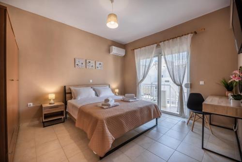 a bedroom with a bed and a large window at Katerina's House in Afantou