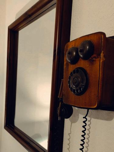 a mirror with a telephone attached to a wall at Il nido di Lele e Schina in Arvier