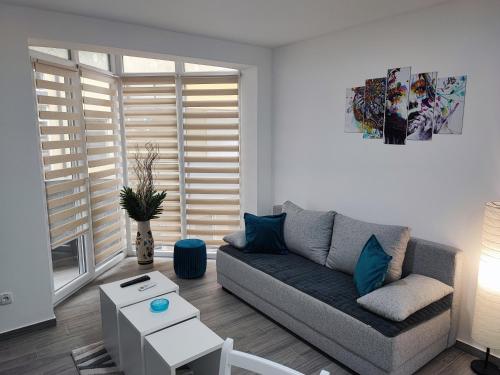 a living room with a couch and a table at White pearl & SPA in Veliko Gradište