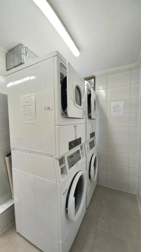 lavadero con 2 lavadora y secadora en Departamento Edificio Aqua Pucón, en Pucón