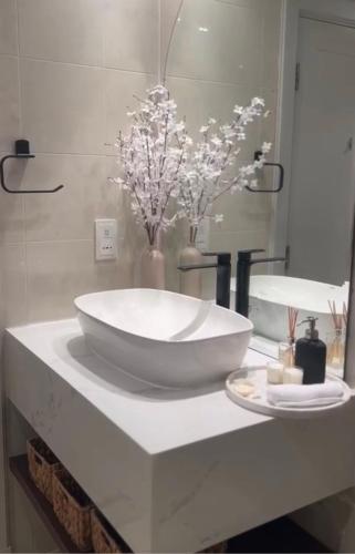 a bathroom with a large white sink on a counter at Beachfront Luxury Apartment-Pearl Island شقه مطله على الشاطئ بجزيرة اللؤلؤه in Doha