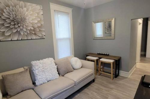 a living room with a couch and a table at Retreat Suite 4 - Downtown Getaway in Grand Rapids