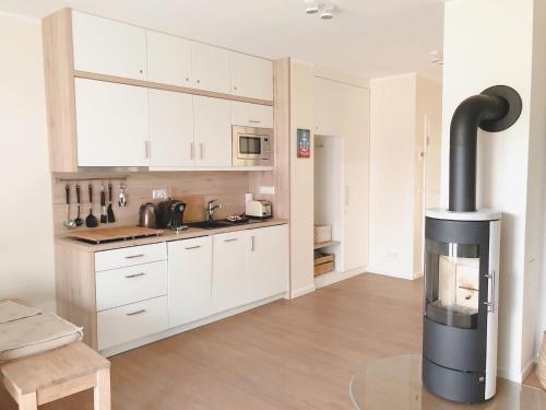 a kitchen with a stove in the middle of a room at PerlePlau in Plau am See