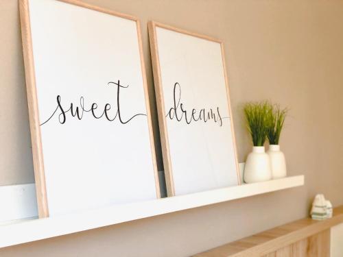a shelf with three mirrors with the words sweet dreams at PerlePlau in Plau am See