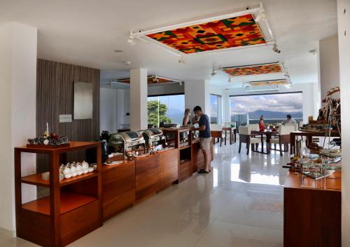 a man standing at a counter in a restaurant at Mount Blue Kandy in Kandy