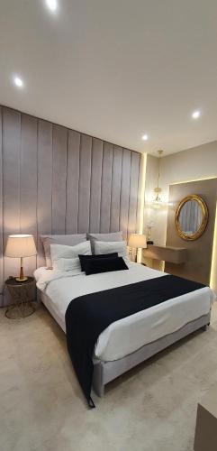 a bedroom with a large bed with a large headboard at Lingos Hotel in Florina