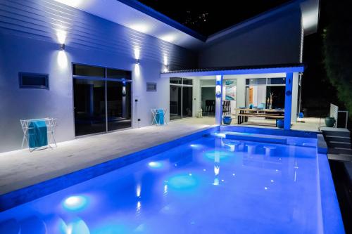 a swimming pool in a house at night at VILLA ARGANDA Infinity Pool Luxury Sea View in Bophut