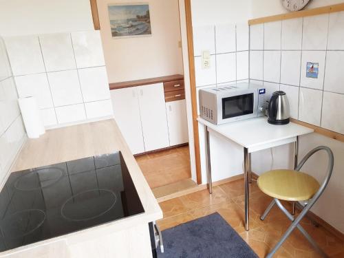 a small kitchen with a table and a microwave at Haus Ajax in Anklam