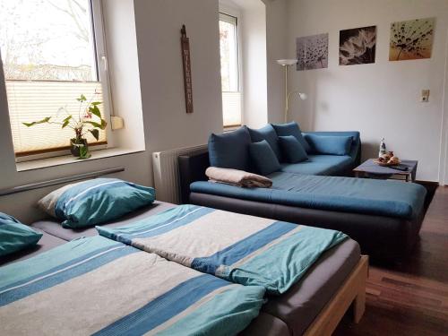 a living room with two beds and a couch at Haus Ajax in Anklam