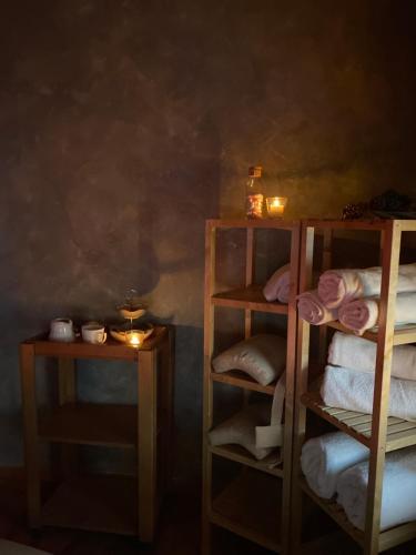 a room with two wooden shelves with towels and candles at Residenza d'Epoca Albergo Grimani in Ampezzo