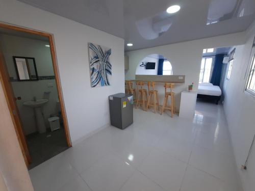 a white room with a kitchen and a dining room at Apartamentos Chalet del Mar in San Andrés