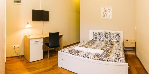 a bedroom with a bed and a desk and a desk at Downtown Core Apartments in Budapest