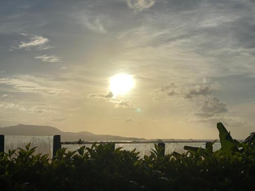 a sun in the sky over a body of water at La Villa Davy in Ducos