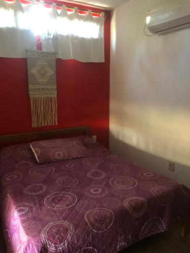 a bedroom with a purple bed with a window at Gran escape! Santa Ana in Cuchilla Alta