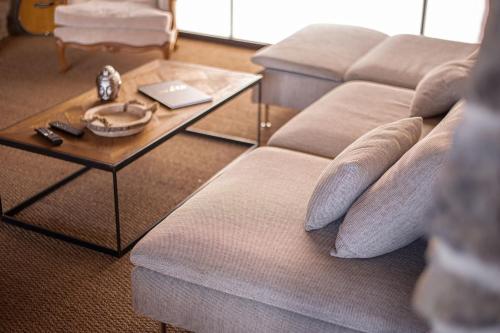 a living room with a couch and a coffee table at Le Refuge de Maïly in Beauraing