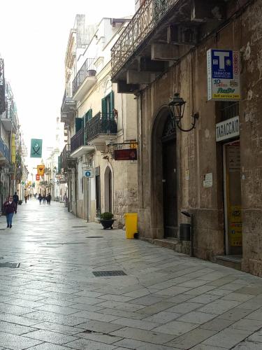 an empty street in a city with buildings at Le camelie in Altamura