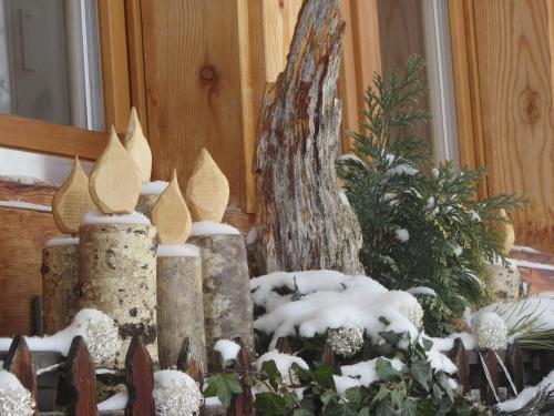 a garden with snow covered rocks and a christmas tree at Pension Staldacher in Hasliberg