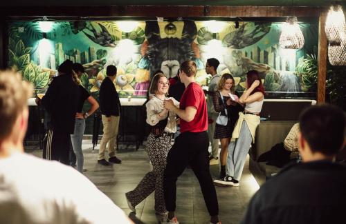 a group of people dancing on a dance floor at Black Llama Hostel Miraflores in Lima