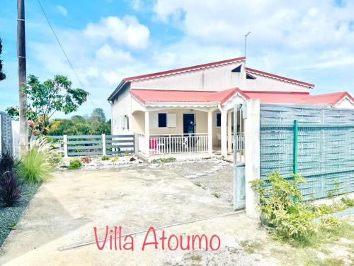 a house with a fence in front of it at Résidence chez Adine in Sainte-Anne