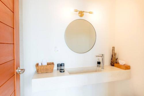 a bathroom with a sink and a mirror at Casa Imox Holbox, apartment 1 in Holbox Island
