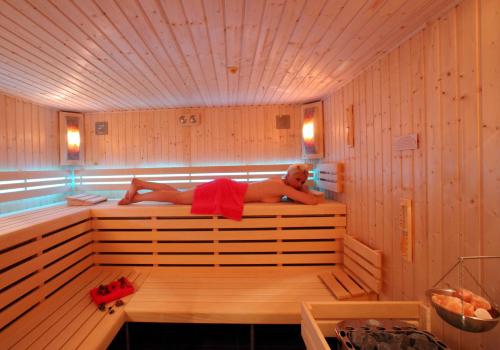 a man is laying in a sauna at Hotel Bornholm in West-Terschelling