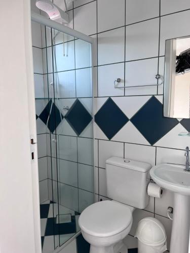 a bathroom with a toilet and a sink at Morada da Marta in Guarda do Embaú