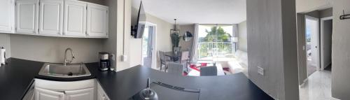 two images of a kitchen with a sink and a kitchen at Stunning Views Best location in Hilo 2BR modern Condo in Hilo