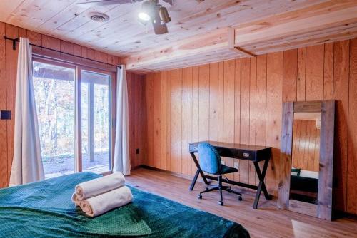 a bedroom with a desk and a bed and a chair at Fall Getaway Resort-3 KING suites, Dog-Friendly in Seeley