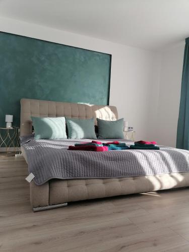 een slaapkamer met een groot bed met een groene muur bij ADC in Sibiu