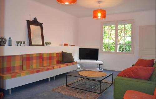 Una sala de estar con un sofá y un televisor. en 2 Bedroom Cozy Apartment In Bergerac, en Bergerac