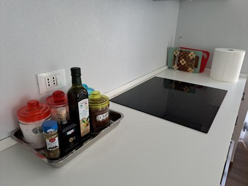 a bottle of wine sitting on a shelf in a kitchen at VILLA ESTER -Residenze dolomitiche- in Pieve di Cadore