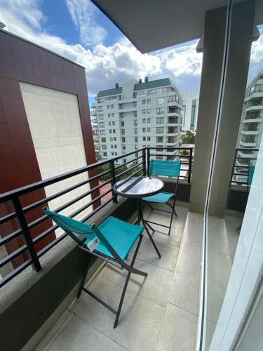 a balcony with two chairs and a table on a building at Departamento Central Valdivia in Valdivia