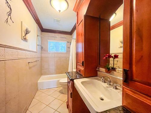 a bathroom with a sink and a toilet and a tub at Villa Sea Haven at Orange Hill Beach - Private Pool in Nassau