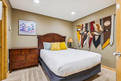 a bedroom with a bed and a dresser at Tannhauser II 15 in Breckenridge