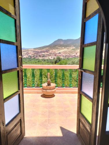 a door open to a patio with a fountain at Villa de l'atlas in Tagadirt