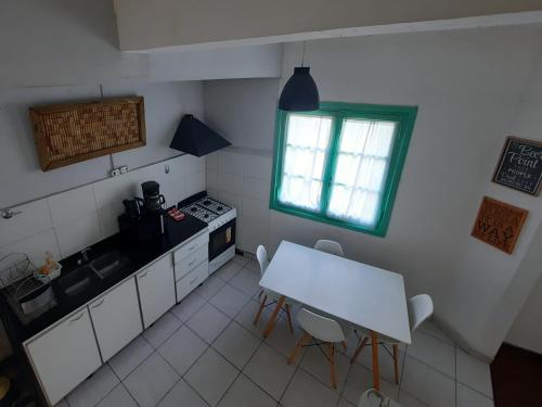 a small kitchen with a table and a window at B&P Departamentos in Mendoza