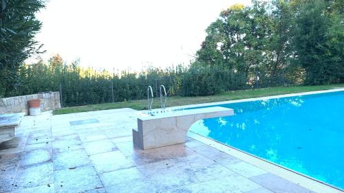a stone bench next to a swimming pool at Villa Valmarana De Toni in Creazzo