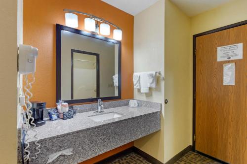 a bathroom with a sink and a mirror at Quality Inn Wooster in Wooster