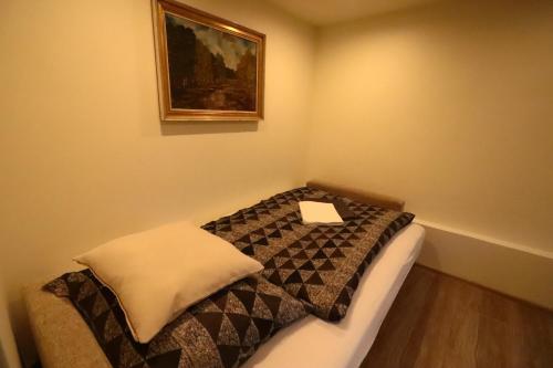 a small bedroom with a bed with a sign on it at Karczma Pod Jesionem in Brdów