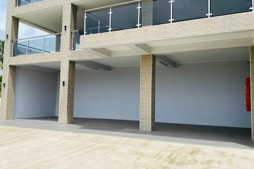 a building with two garage doors on the side at Lovely 4-bedroom Holiday home with free parking. in Lautoka
