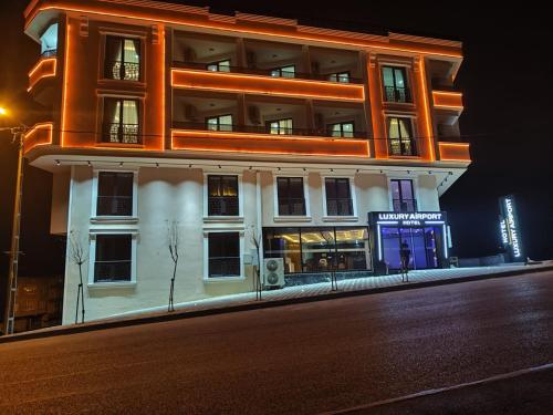 a building on the side of a street at night at Luxury Airport Hotel By Zazzoni-İstanbul Airport in Arnavutköy