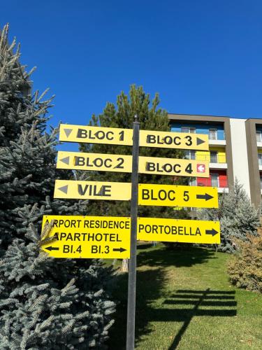 a street sign in front of a building at Fly Airport Residences & Therme-SELF CHECK-IN in Otopeni