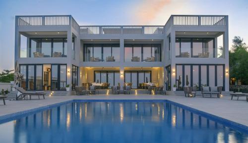 a house with a swimming pool in front of it at Villa Bluu Zanzibar in Jambiani